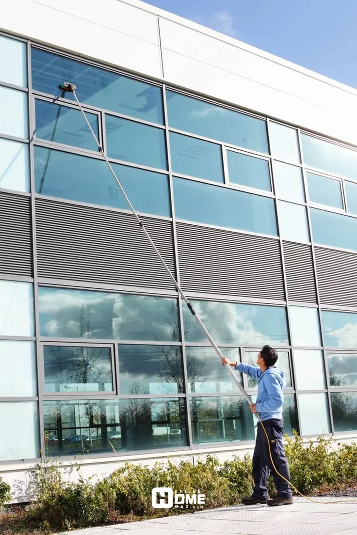 An extendable telescopic pole with a squeegee attachment for window cleaning at height."
