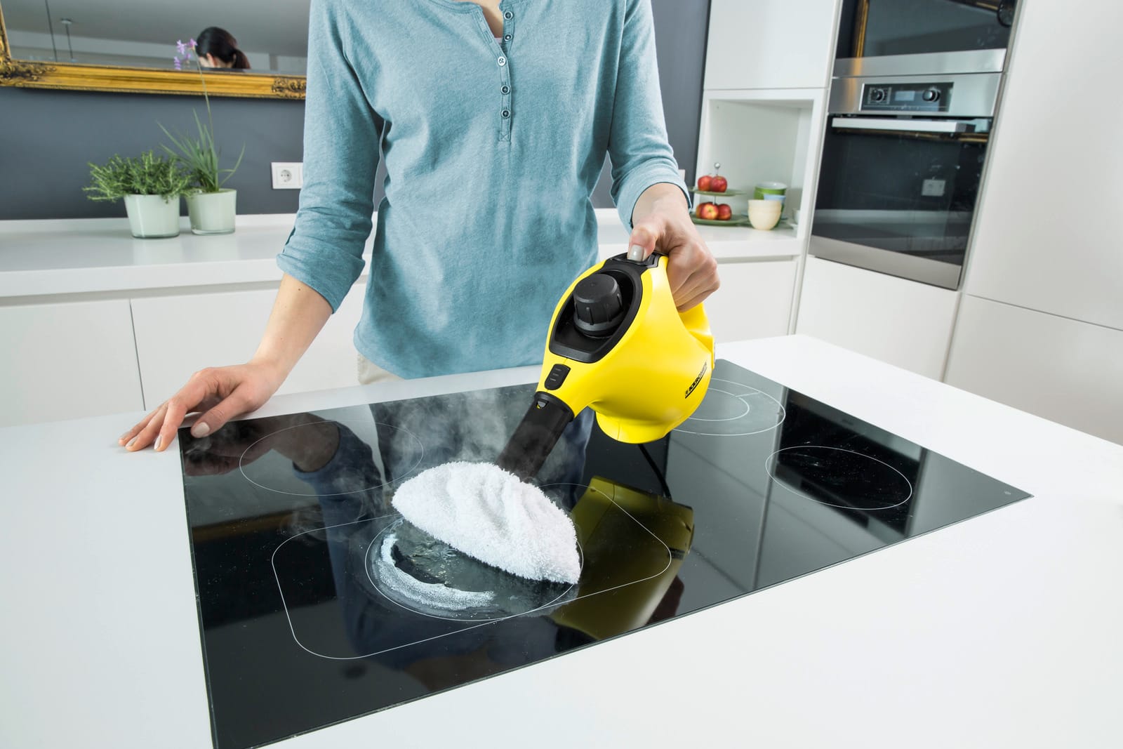 yellow steam cleaner to clean an induction cooktop with steam