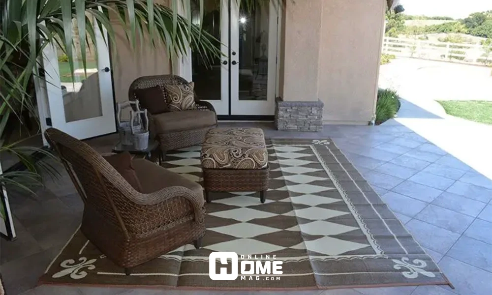 A cozy outdoor space with a decorative rug, simple chairs, and a modern design.
