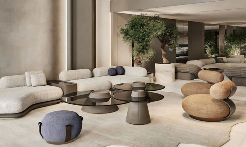 Modern sofa living room with neutral curved sofas, designer coffee tables, and indoor olive trees